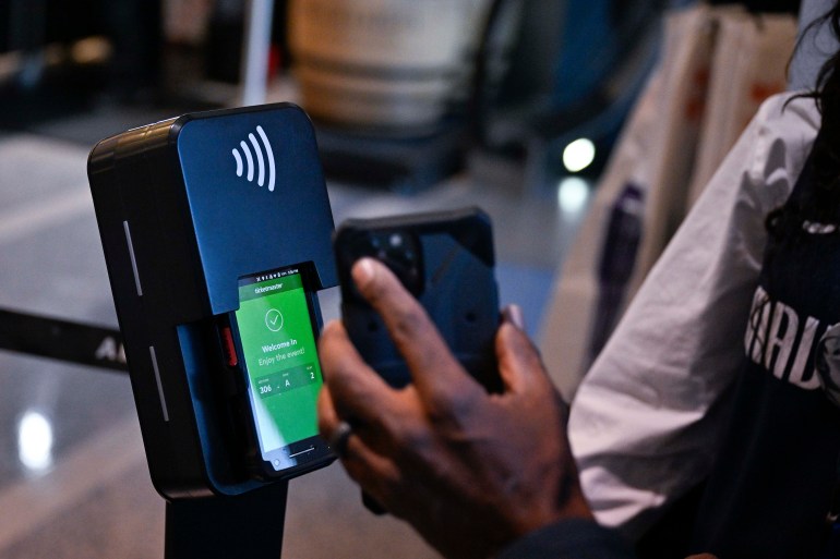 A Dallas Mavericks fan scans a ticket using a Ticketmaster kiosk