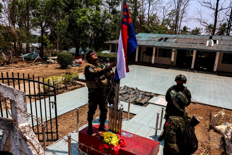 KNLA soldiers raising the Karen national flag a Myanmar military base at Thingyan Nyi Naung village on the edge of Myawaddy