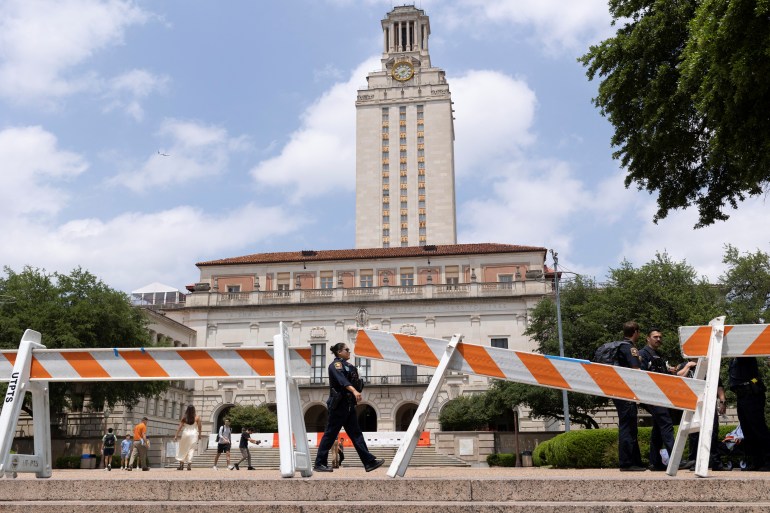 Barricades are erected in front of the limestone tower at UT Austin.