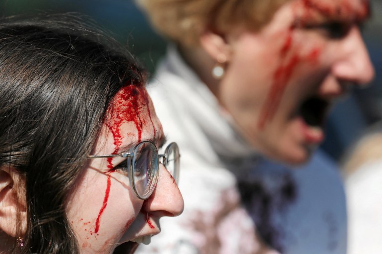 Ukrainian activists stage protests outside the Soviet Military Cemetery where Russia's ambassador to Poland, Sergei Andreyev (not pictured), lays flowers to mark the anniversary of the victory over Nazi Germany, in Warsaw, Poland, May 9,2024. Agencja Wyborcza.pl/Slawomir Kaminski via REUTERS ATTENTION EDITORS - THIS IMAGE WAS PROVIDED BY A THIRD PARTY. POLAND OUT. NO COMMERCIAL OR EDITORIAL SALES IN POLAND.