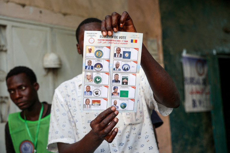 A poll worker holds up a ballot during the presidential race in Chad.