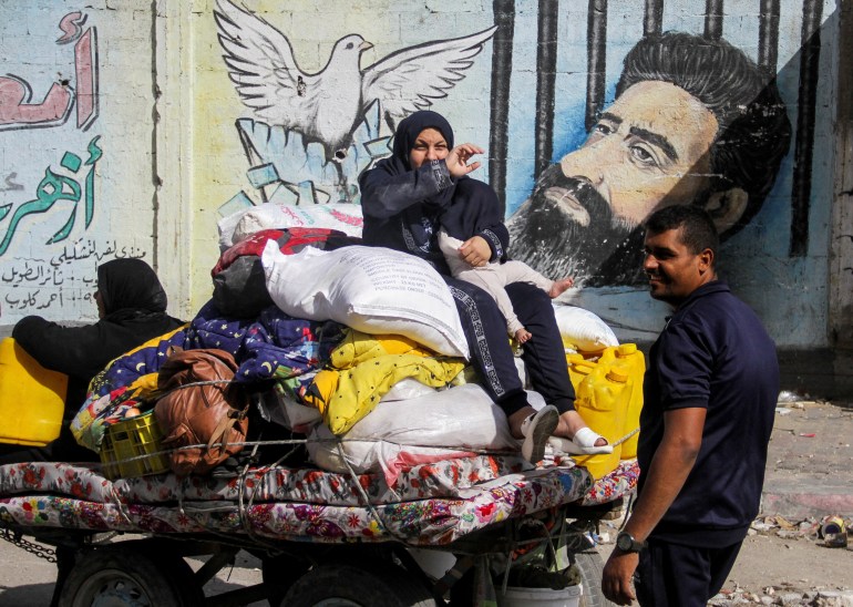 A displaced Palestinian woman, who fled Jabalia after the Israeli military called on residents to evacuate, sits atop her belongings as she travels in an animal-drawn cart, amid the ongoing conflict between Israel and Hamas, in Gaza City, May 12, 2024. REUTERS/Mahmoud Issa TPX IMAGES OF THE DAY