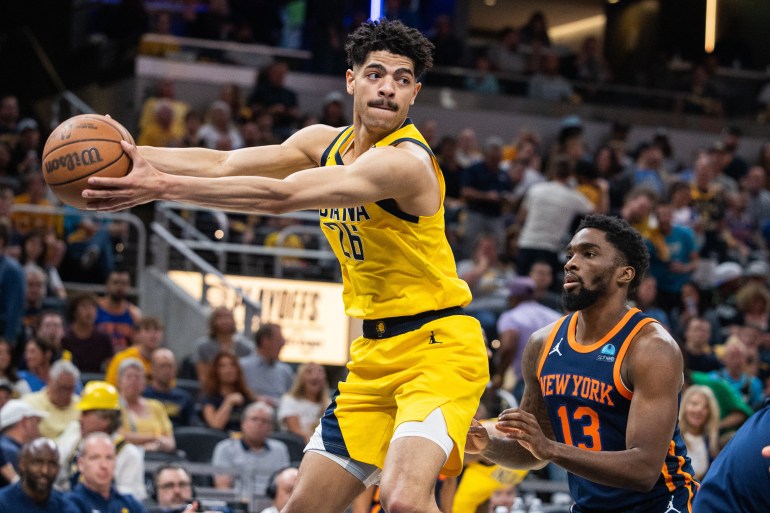 May 12, 2024; Indianapolis, Indiana, USA; Indiana Pacers guard Ben Sheppard (26) rebounds the ball over New York Knicks guard Shake Milton (13) during game four of the second round for the 2024 NBA playoffs at Gainbridge Fieldhouse. Mandatory Credit: Trevor Ruszkowski-USA TODAY Sports