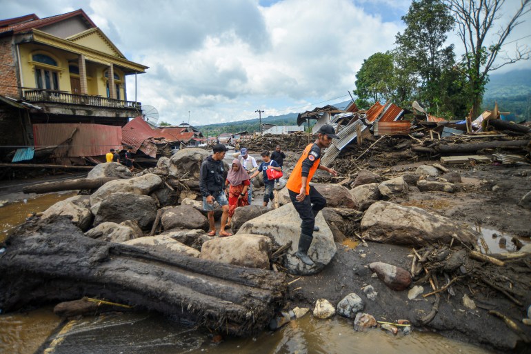 A man clambers over debris following Saturday night's disaster.