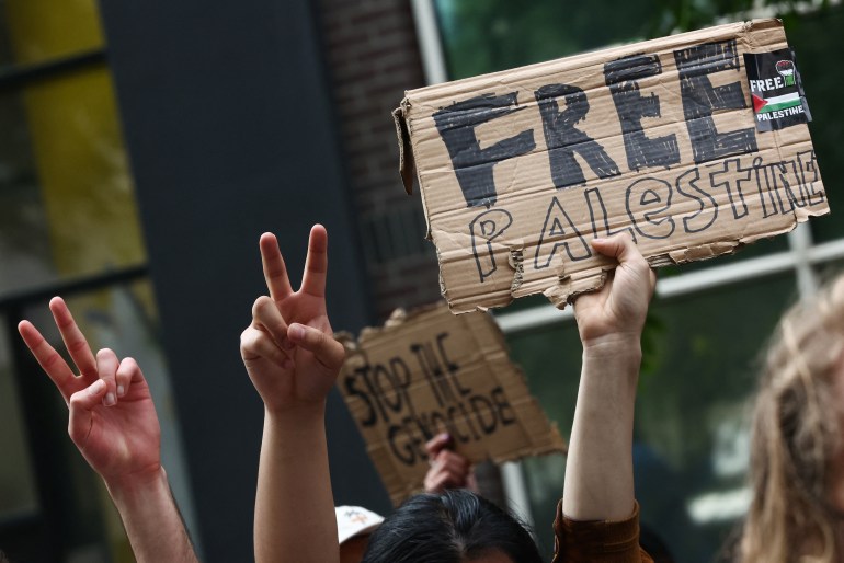 People hold free Palestine placards