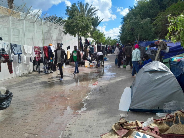 The passage where refugees are camped. It's crowded and a leak makes the ground wet