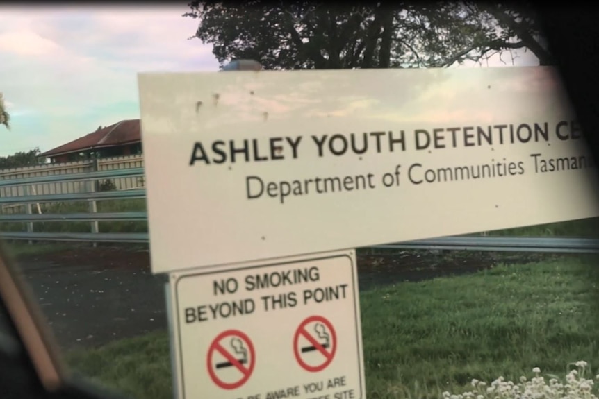 View of signage at youth detention centre as car leaves facility.