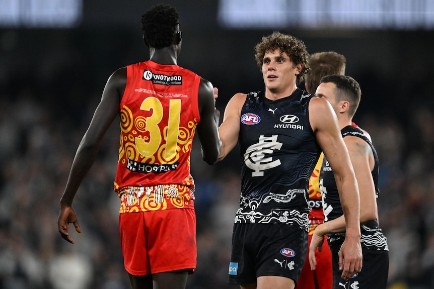 Mac Andrew and Charlie Curnow shake hands