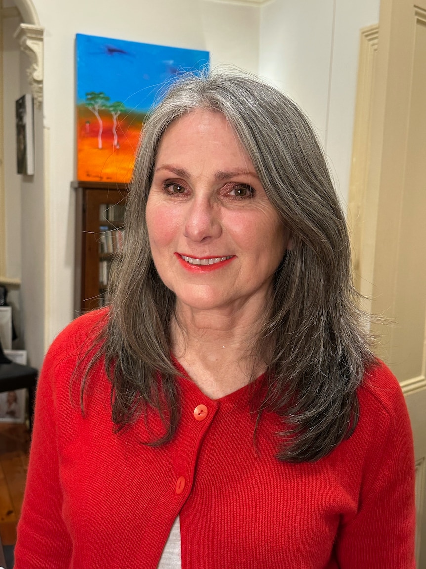 A woman wearing a red cardigan 