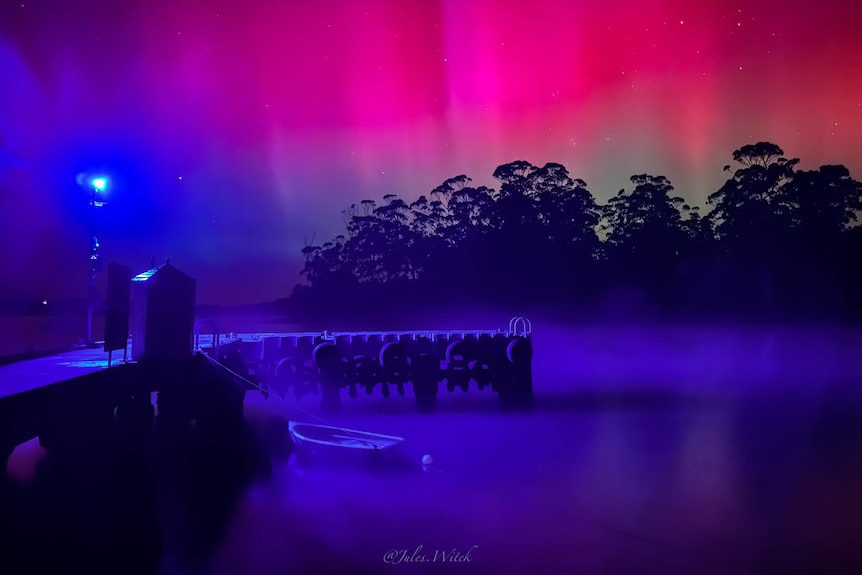 Stunning blue and pink colours highlight a pier.