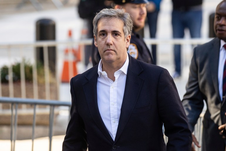 Michael Cohen, wearing a dark blazer and white shirt, arrives to court in a 2023 photo.