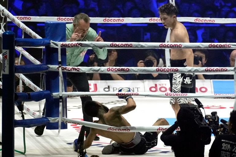 Naoya Inoue of Japan stands over xxx after knocking him down Luis Nery of Mexico in the sixth round of a boxing match for the unified WBA, WBC, WBO and IBF super bantamweight world titles in Tokyo, Monday, May 6, 2024. (AP Photo/Hiro Komae)