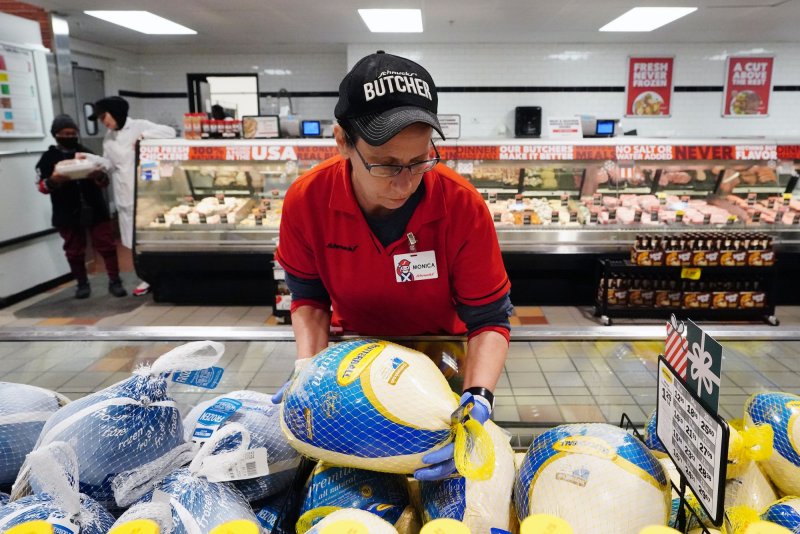 Monica Treece, a butcher at the Richmond Heights Schnucks Market, arranges Thanksgiving turkeys in the freezer section on the first day of sales in Richmond Heights, Missouri on November 15, 2022. The Labor Department said consumer prices rose at a slower rate than expected in April. File Photo by Bill Greenblatt/UPI