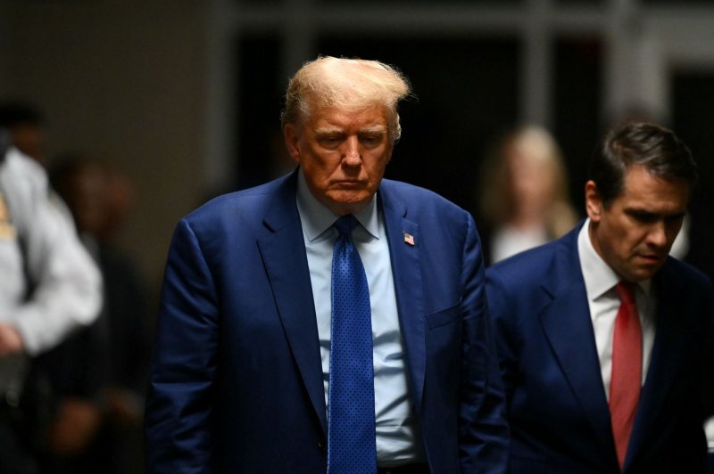 Former President Donald Trump (C) walks over to speak to reporters as he leaves his criminal trial at Manhattan criminal court in New York on Thursday. Pool Photo by Angela Weiss/UPI