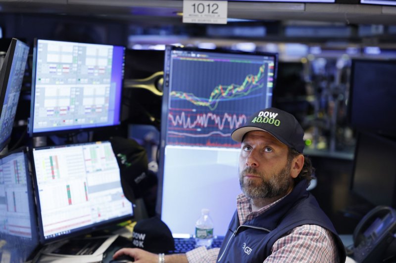 A trader wears a baseball cap reading "40,000" as he works on the floor of the New York Stock Exchange (NYSE) on Wall Street in New York City on Thursday. The Dow Jones Industrial Average closed Friday at 40,000 for the first time after briefly topping 40,000 on Thursday before closing at 39,965 in late trading. Photo by John Angelillo/UPI