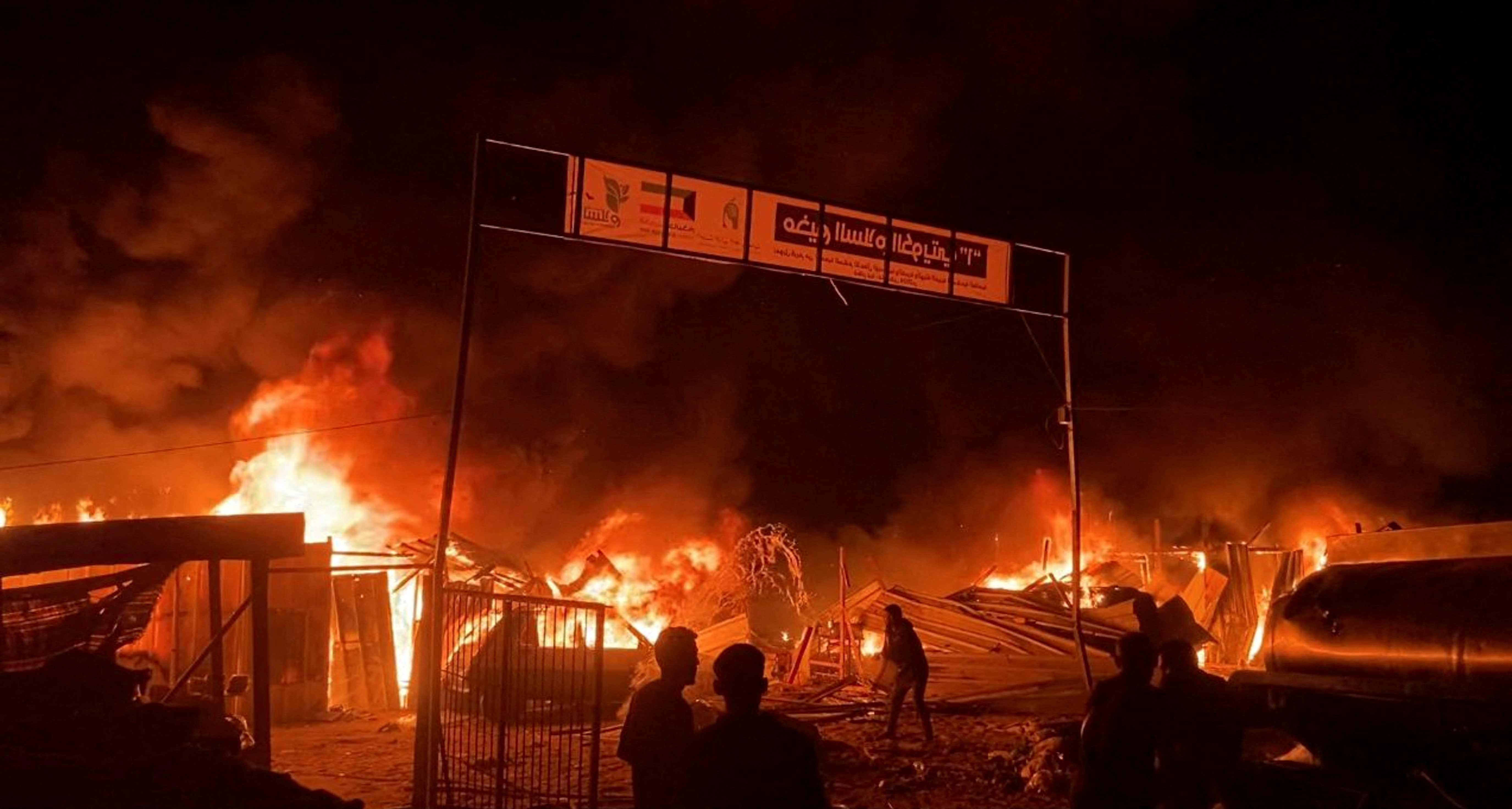 Fire rages following an Israeli strike on an area designated for displaced Palestinians in Rafah