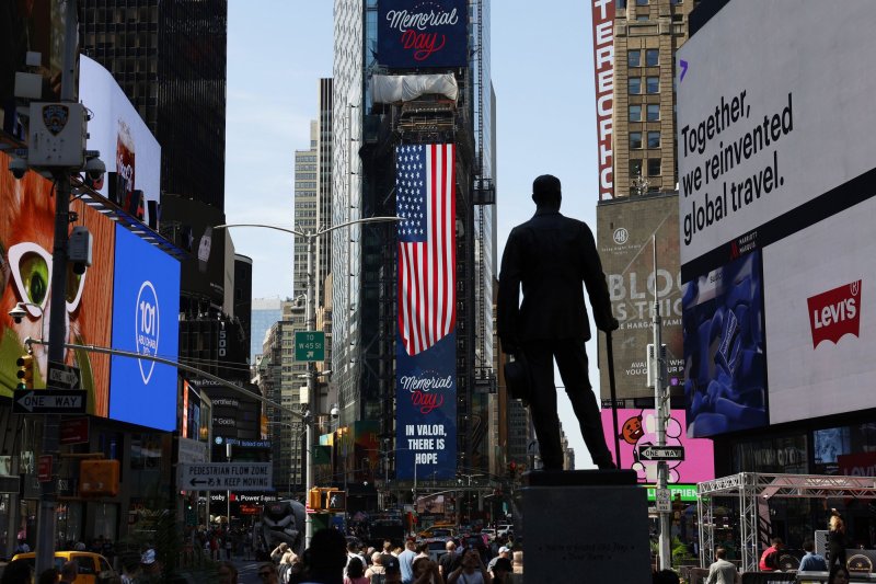 American flags are displayed in Times Square on the Friday of Memorial Day weekend in New York City. The 36th annual celebration in the city celebrates those who serve and provides a chance for people to meet U.S. sailors, Marines and coast guardsmen. Photo by John Angelillo/UPI