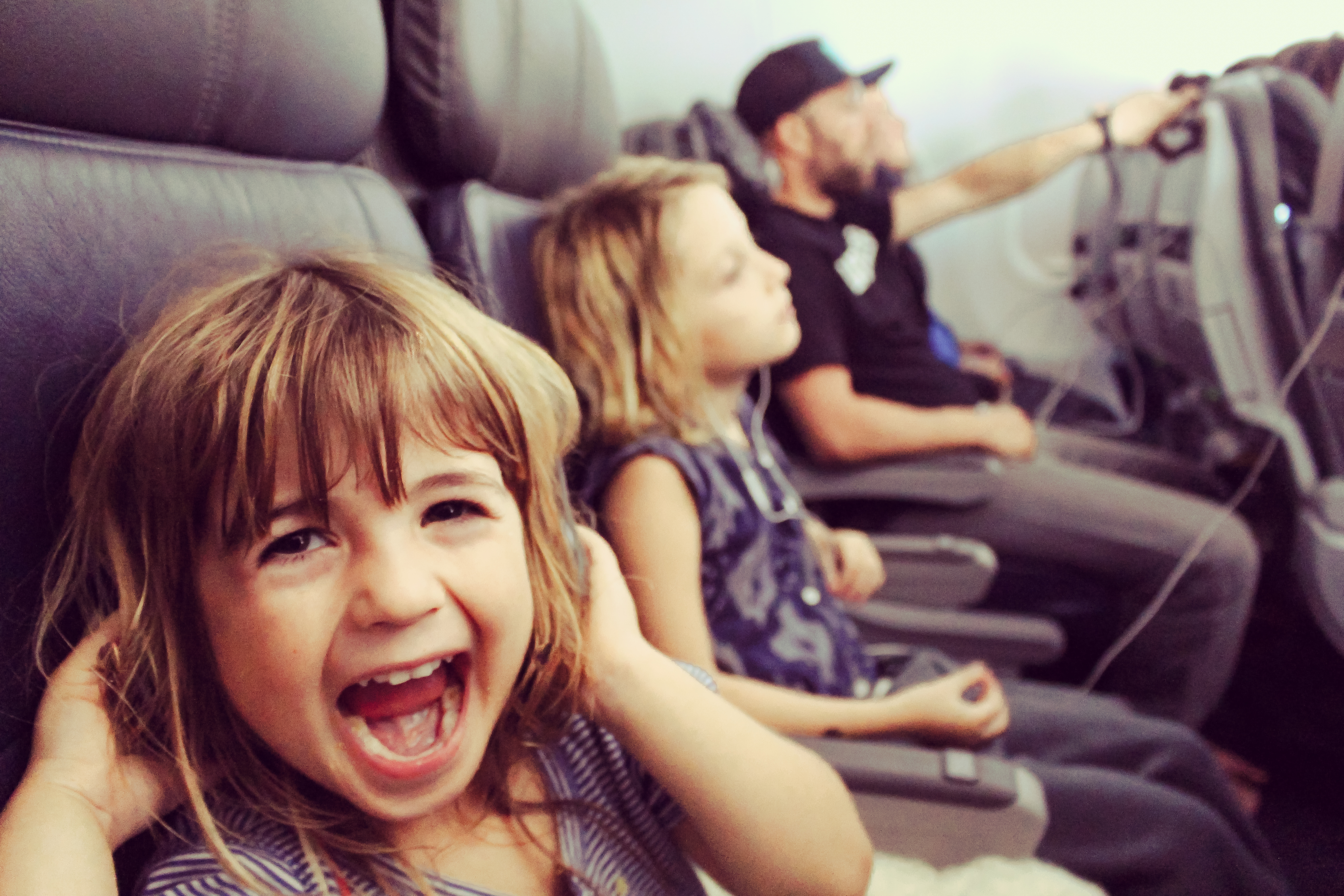 Little kid makes funny faces on an airplane