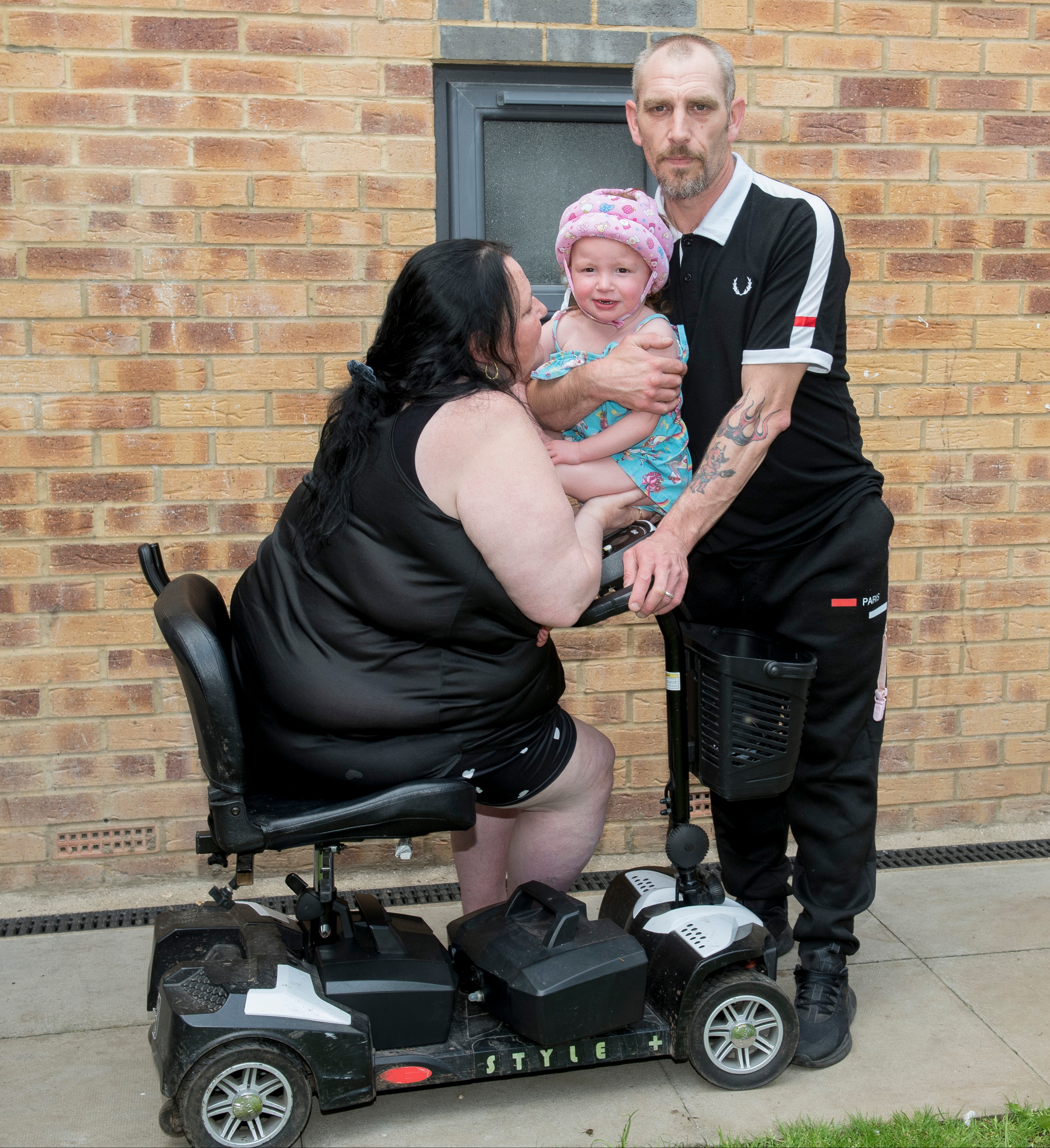 Lucy and Darren Fowles, pictured here with one of their children, have been living among sewage for the last year