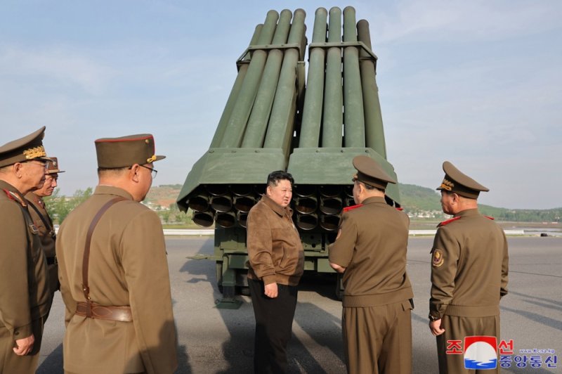 A photo released by the official North Korean Central News Agency shows North Korean leader Kim Jong Un (C) overseeing the test fire of the 240mm multiple rocket launcher system in an undisclosed location in North Kore on May 10. Photo by EKCNA/EPA-EFE