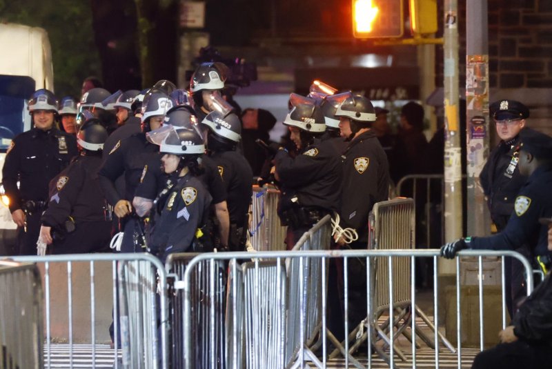 NYPD police officers wearing riot gear stand on Broadway after the streets surrounding the campus at Columbia University became a frozen zone Tuesday night in New York City. Hundreds of officers entered the campus and Hamilton Hall where a group of pro-Palestinian protesters were barricaded. Dozens were arrested. Photo by John Angelillo/UPI