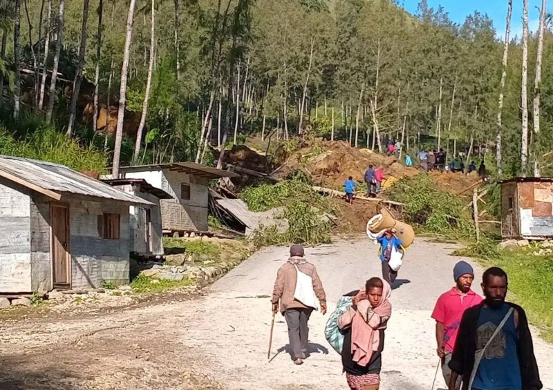 People walk with their belongings in the area where a landslide hit the village of Kaokalam, Enga province, Papua New Guinea, on Friday. On Monday, officials said that more than 2,000 people were buried alive, officials said Monday. Photo by Ninga/EPA-EFE/NINGA ROLE BEST QUALITY AVAILABLE AUSTRALIA AND NEW ZEALAND OUT EDITORIAL USE ONLY EDITORIAL USE ONLY