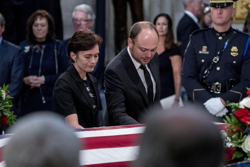 Vladimir Kara-Murza and his wife Yevgenia pay their respects before the casket of Sen. John McCain, R-Ariz., as he lies in state in the Rotunda of the U.S. Capitol, Friday, Aug. 31, 2018, in Washington. Pool photo by Andrew Harnik/UPI