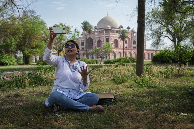 Sharma, shooting a YouTube live for her history channel from Humayun's tomb, a Mughal-era monument in Delhi, India. (Md Meharban/Al Jazeera)