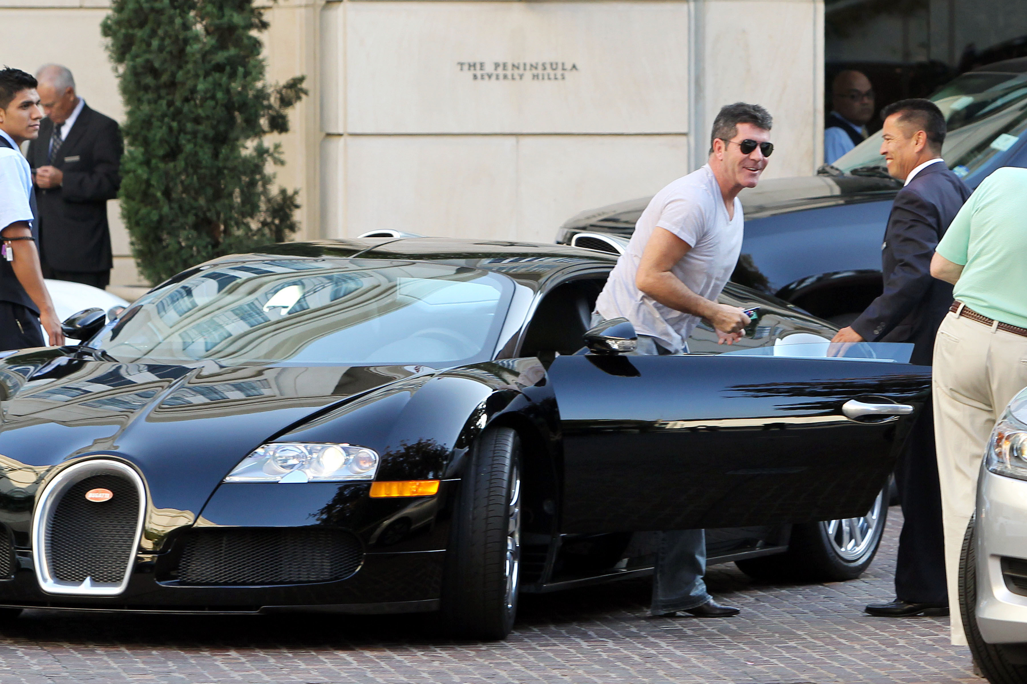 Cowell hopping out of the Bugatti in 2013