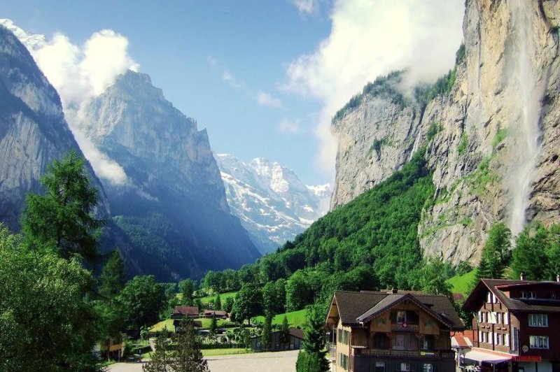 The Swiss village of Lauterbrunnen, tucked into a picturesque Alpine valley of waterfalls and snowy peaks, is considering charging day-trippers a fee to visit in an effort to curb overtourism. Photo courtesy of Halsteadk/Wikimedia Commons