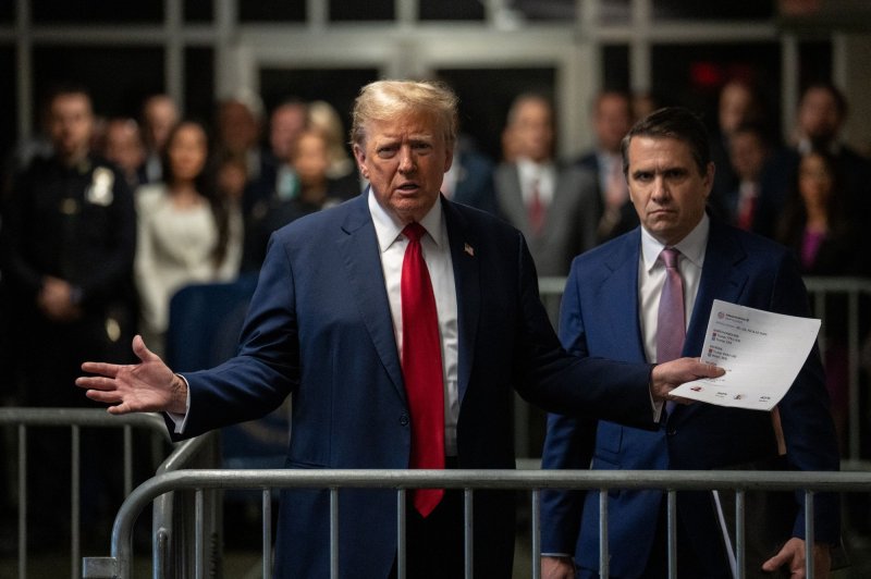 Former President Donald Trump speaks to reporters as he arrives for his trial at Manhattan Criminal Court in New York on Thursday. Pool photo by Jeenah Moon/UPI