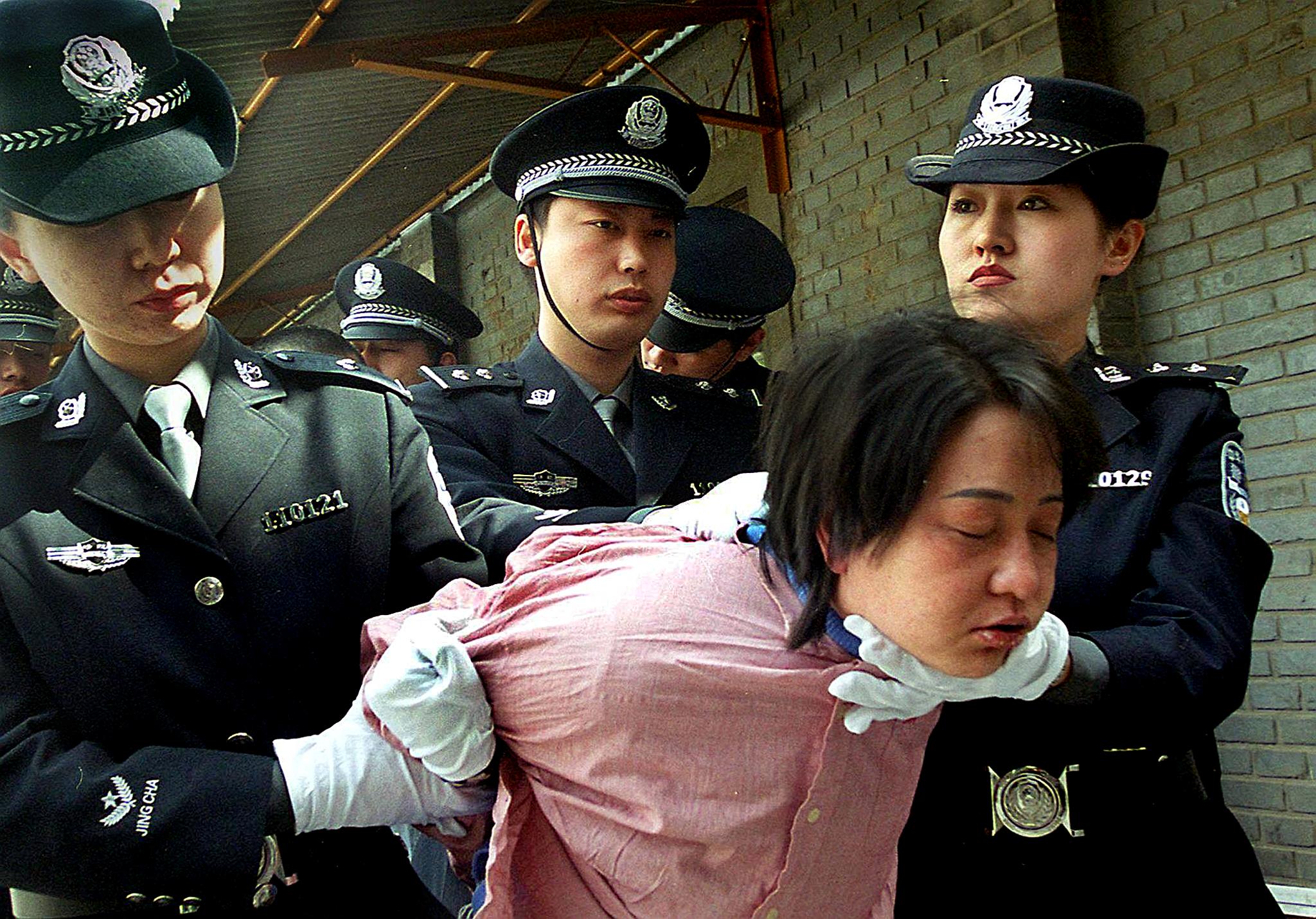 A female prisoner is dragged to her execution in Beijing on April 20, 2001