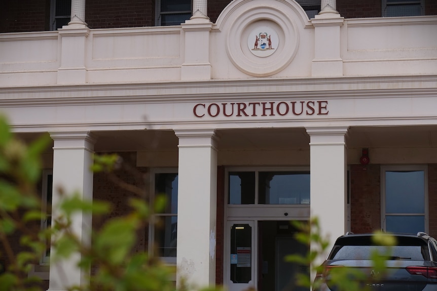 A historic-looking building with "Courthouse" lettered on the facade.