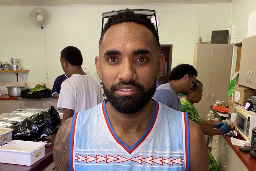 A man wearing a blue singlet top with writing saying "Samoa".