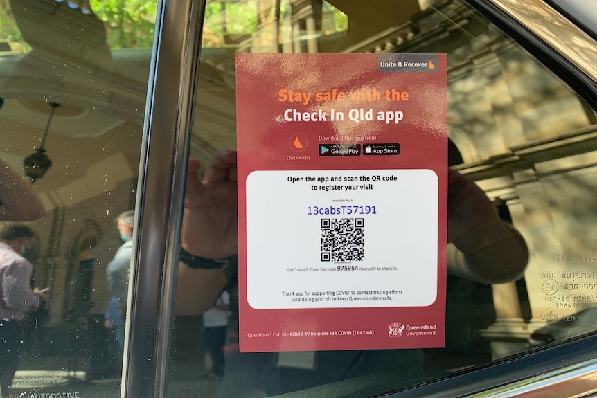 COVID check-in sign on the back window of a taxi.