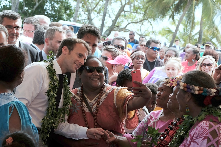 Macron taking a selfie with residents of New Caledonia.