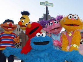 FILE - Characters from Sesame Street Live appear on the street by Madison Square Garden in New York, Feb. 10, 2010. MacArthur Foundation will donate $100 million to the winner of its 100&Change competition. The first 100&Change challenge was awarded in 2017 to a collaboration between Sesame Workshop and the International Rescue Committee to provide educational programming to refugee children in the Middle East.