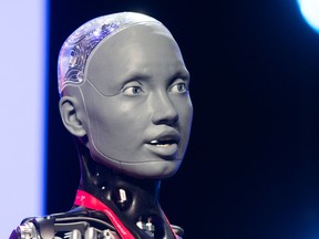 Ameca, a humanoid robot created by Engineered Arts, takes part in an AI interview with Alberta Innovates CEO Laura Kilcrease during Inventures at the Telus Convention Centre in Calgary