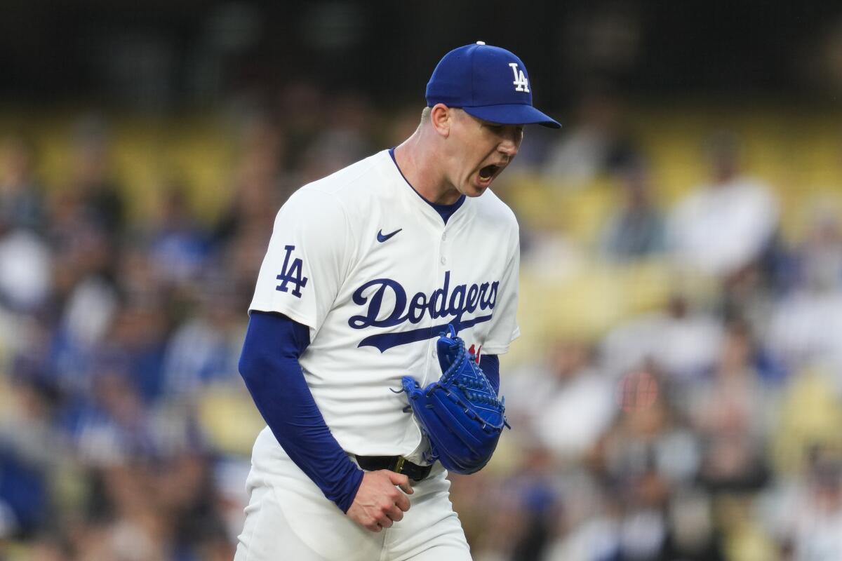 Dodgers starting pitcher Walker Buehler reacts after the first inning against the Colorado Rockies.