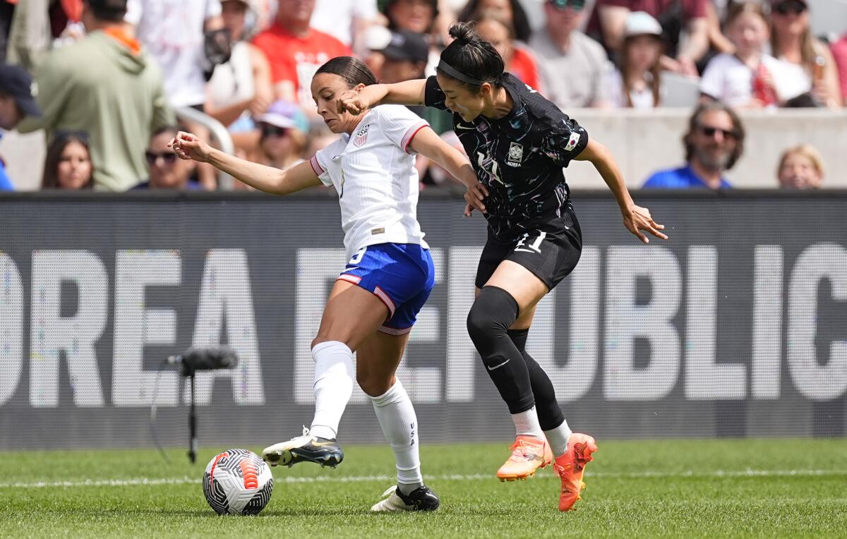 U.S. forward Mallory Swanson, left, tangles with South Korea forward Choe Yuri.