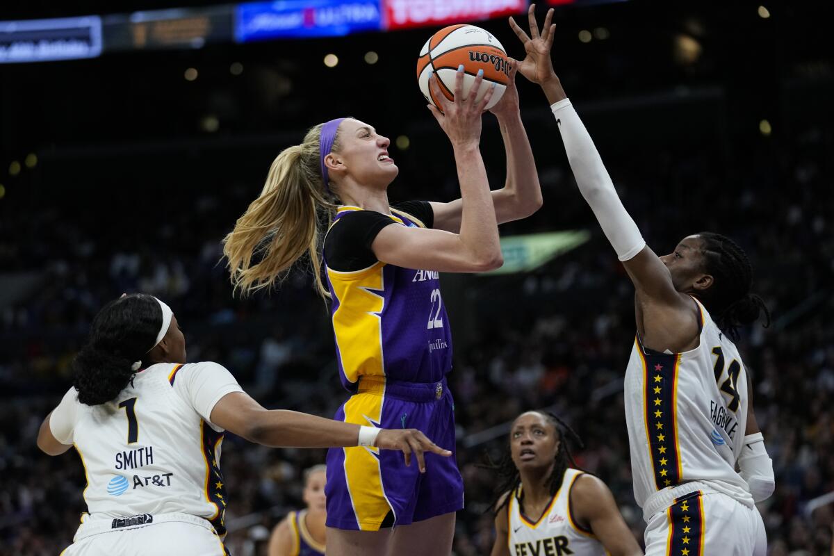 Sparks forward Cameron Brink shoots in front of Indiana Fever center Temi Fagbenle during a game.