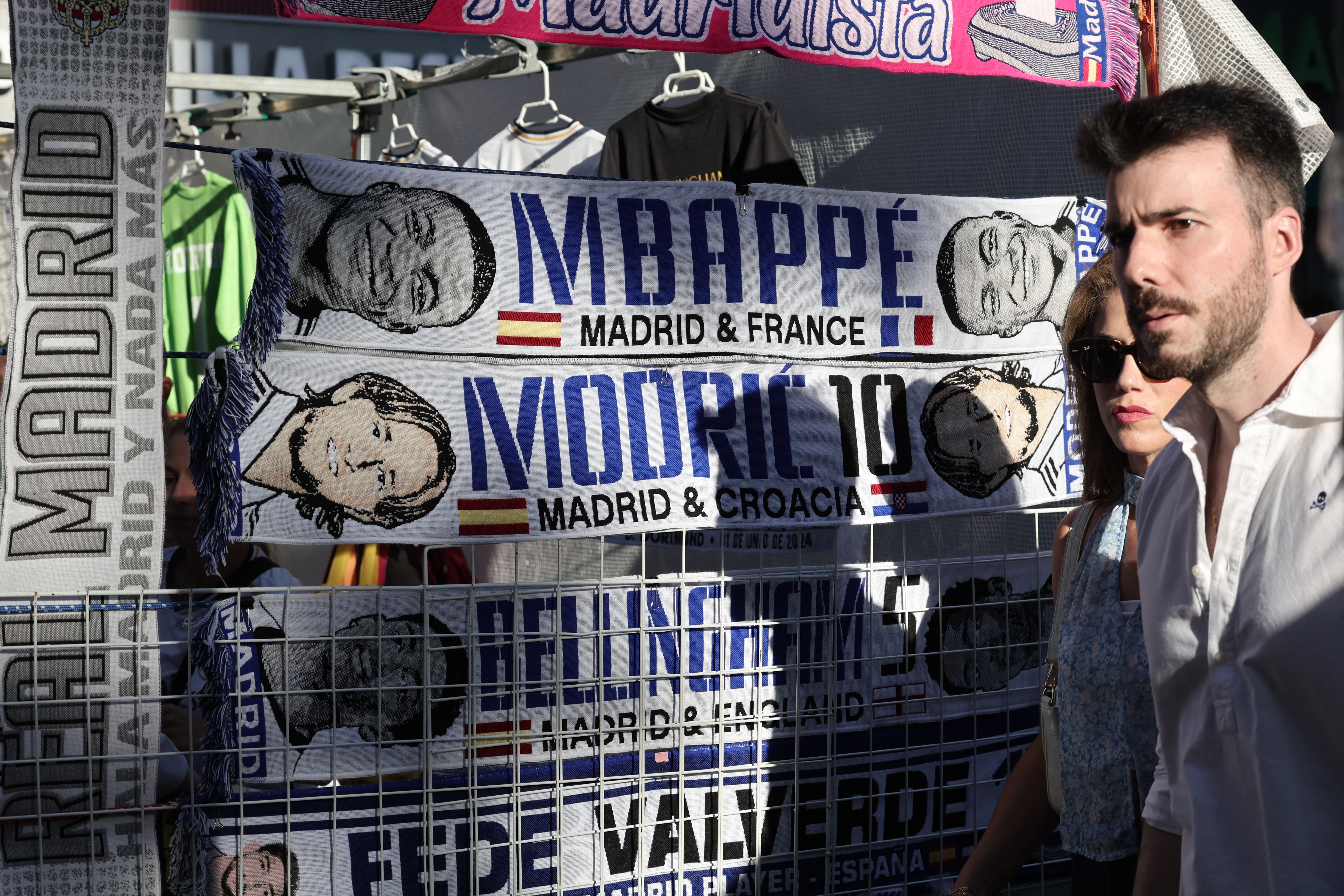 (FILES) Football scarves of French footballer Kylian Mbappe , Croatian player Luka Modric and Briton Jude Bellingan are displayed at a street vendor stand outside the Santiago Bernabeu stadium in Madrid prior to the celebration in London of the UEFA Champions League final football match between Borussia Dortmund and Real Madrid, on June 1, 2024. […]