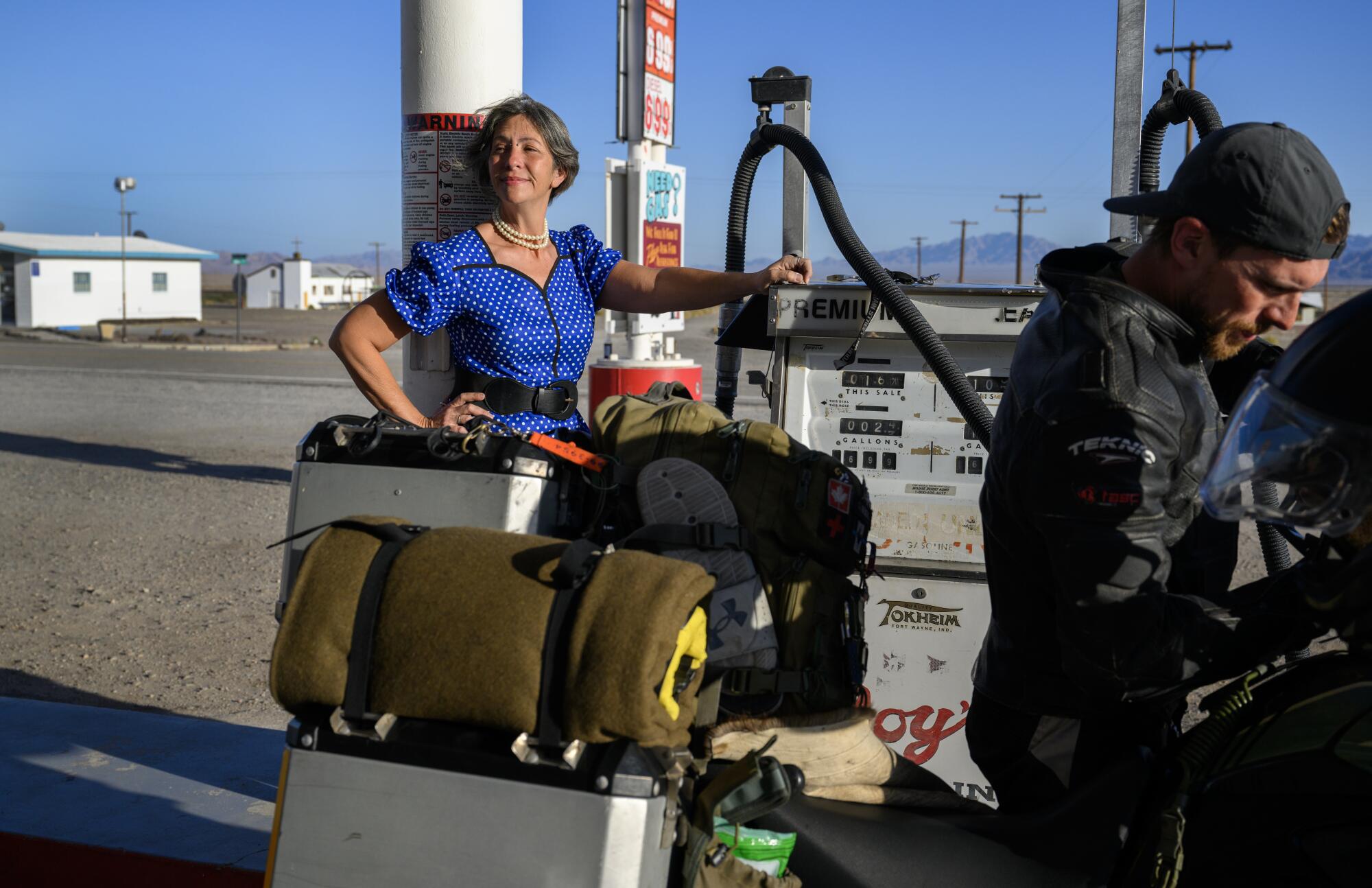 Assistant manager Nicole Rachel next to a gas pump.