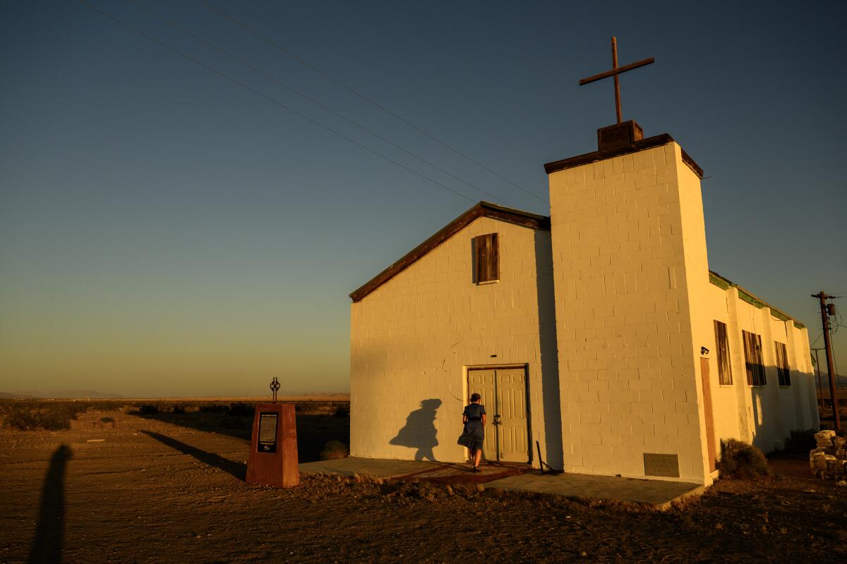 AAssistant Manager Nicole Rachel unlocks the small historic church for tourists