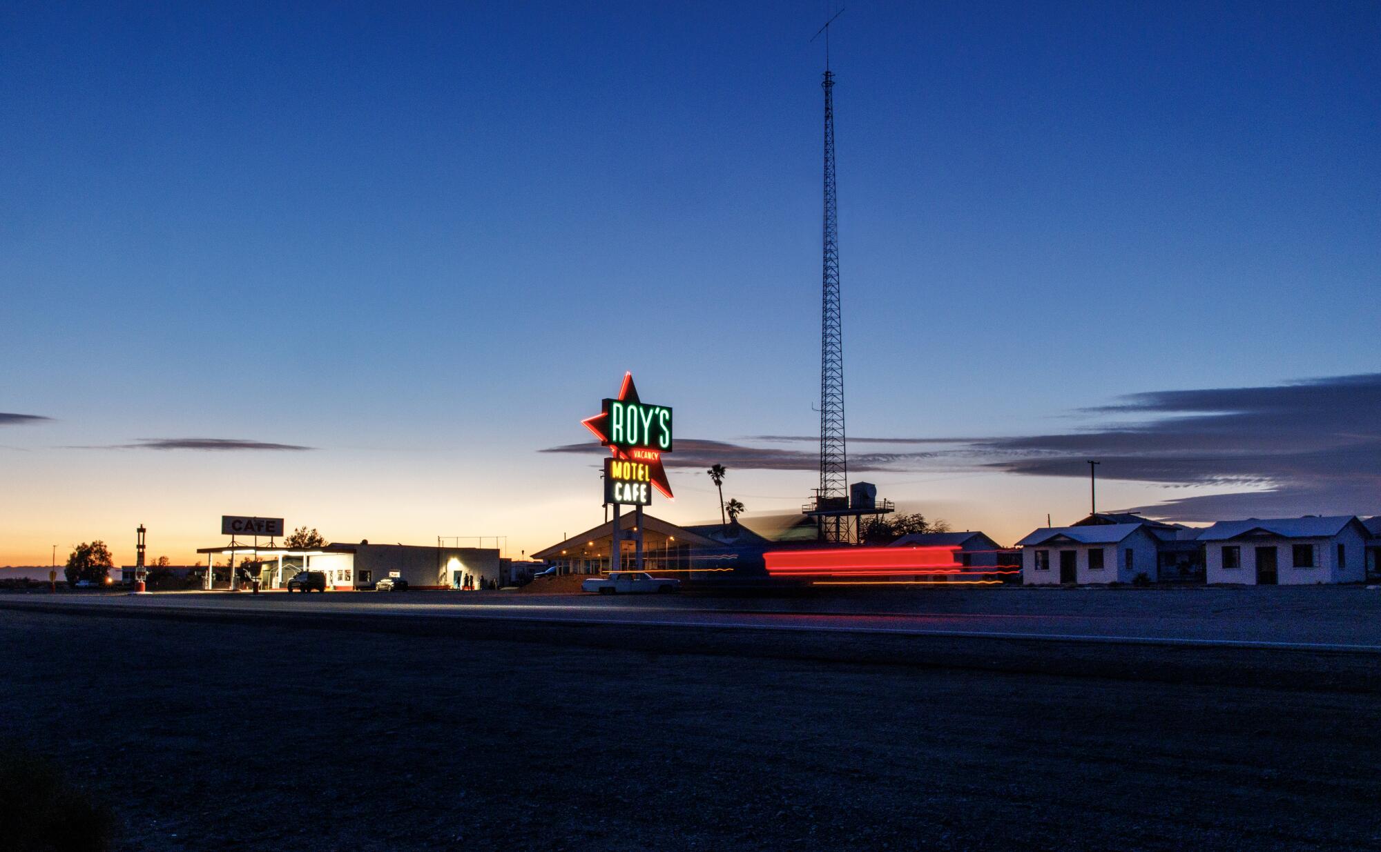 Roy's Motel and Cafe sign in Amboy illuminated after the sun goes down.