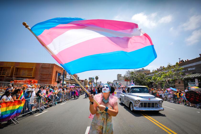 Sister Yesate of the Sisters of Perpetual Indulgence waved a transgender flag while walking the annual San Diego Pride Parade in Hillcrest on July 13.