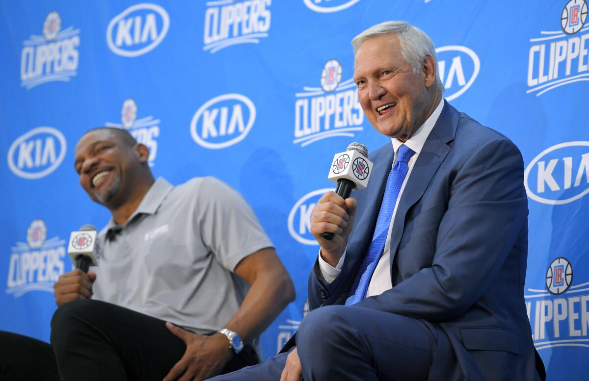 Jerry West speaks during news conference while Clippers coach Doc Rivers sits beside him and laughs in 2017. 