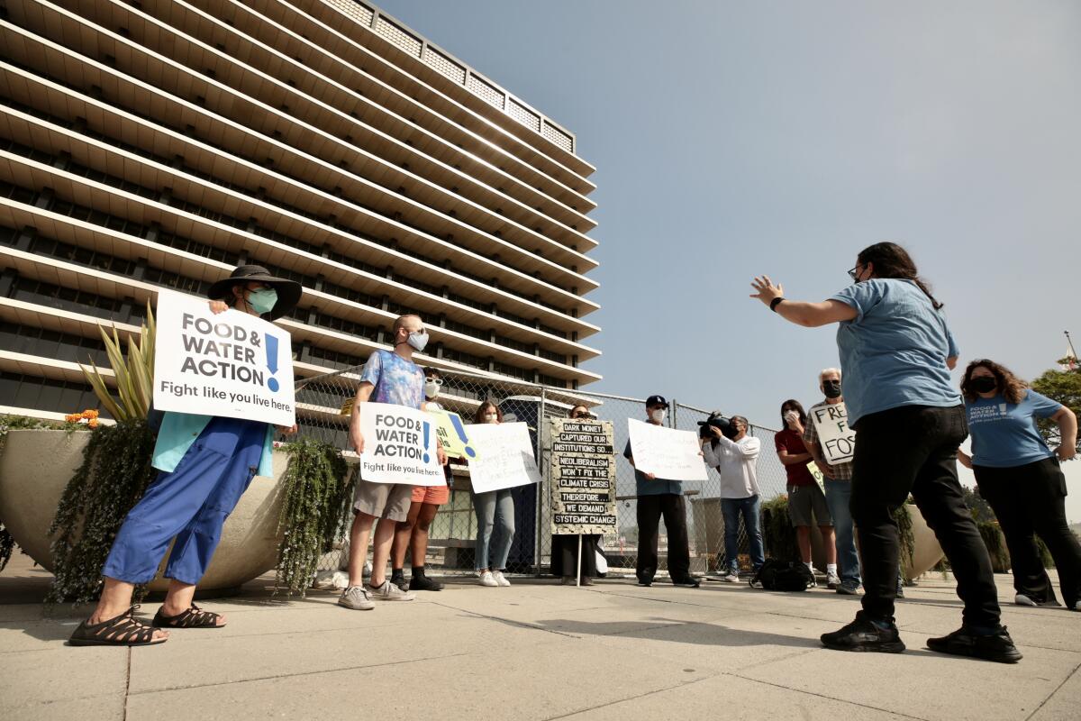 People hold signs in front of a building.