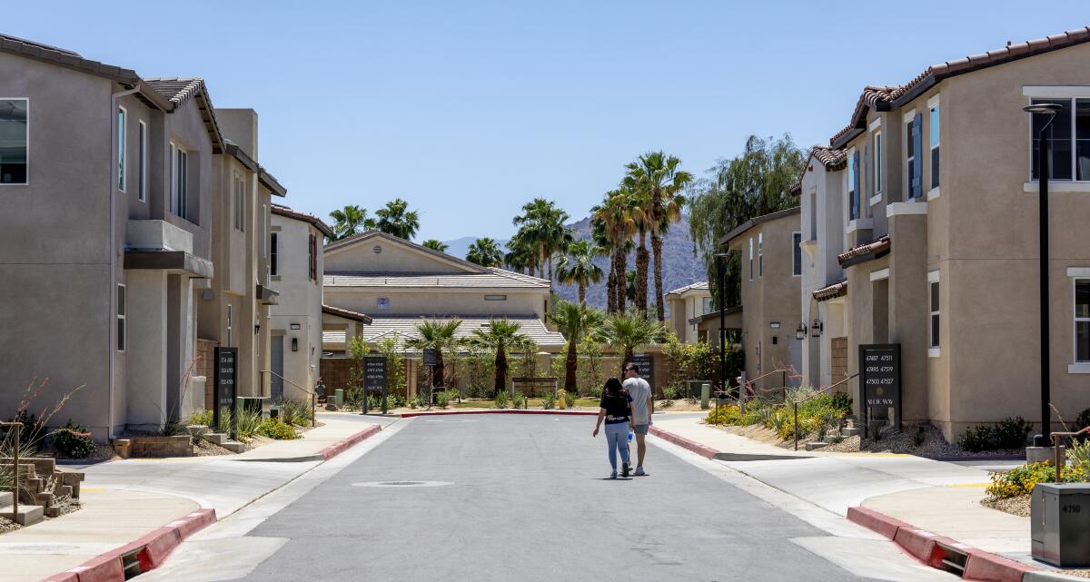 Two people on an empty suburban street