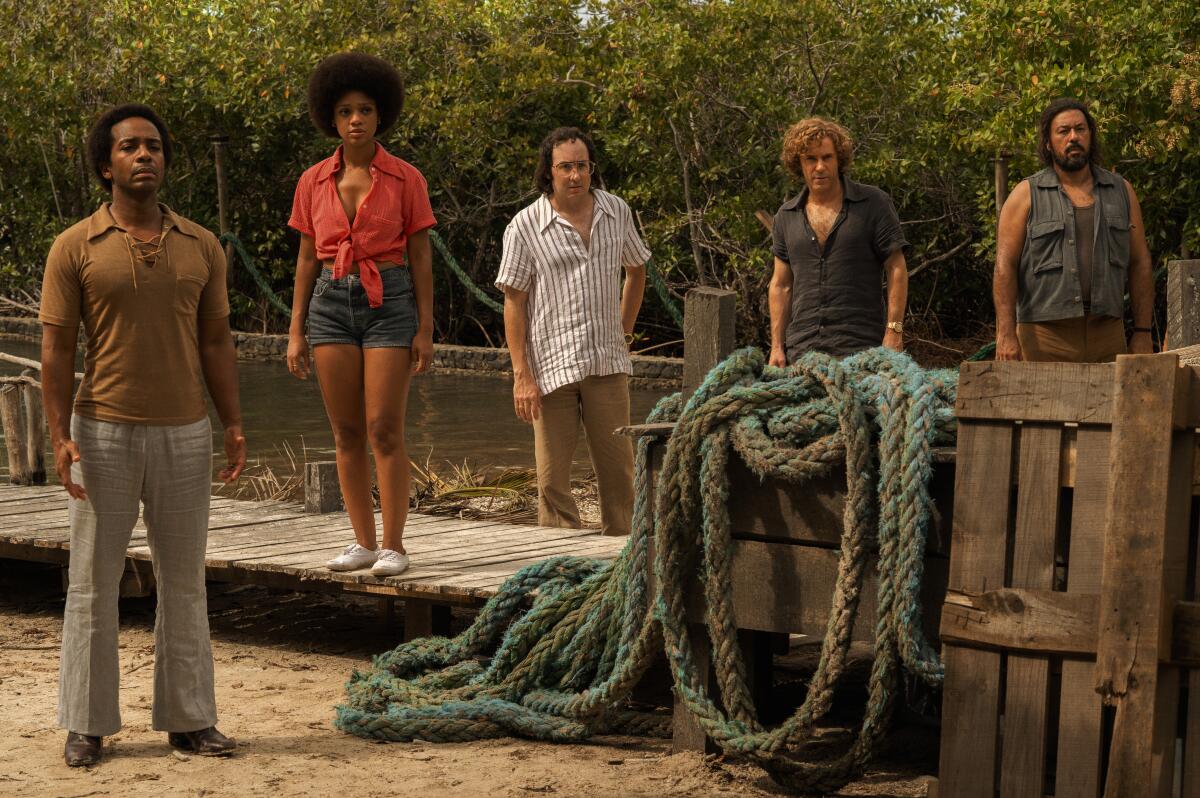 A group of five people standing on a dock.